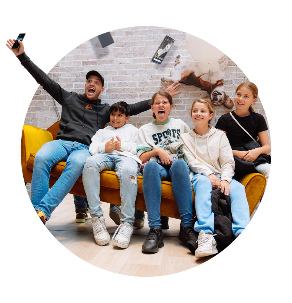 A happy group of people sitting on a sofa at an event. 